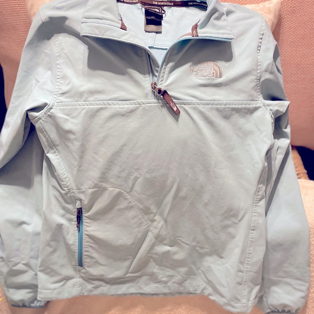 Light blue running jacket by the NorthFace